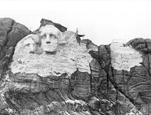 Construction underway, with Jefferson leftmost, before unstable rock necessitated a design change