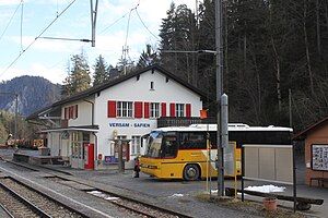 Two-story stone building with gabled roof next to double-track railway line