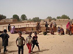 Villagers disassembling a lean-to in Inates