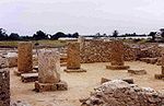 A picture of four stone pillars which once held up a house.