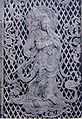 Relief of a Krishna previous Bodhisattva playing a flute on the temple's 8th century Octagonal Lantern.