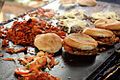 Tortas Oaxaquenas being prepared on a griddle.