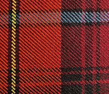 Close-up view of scarlet red, black, yellow, azure bleu, and crimson red tartan cloth