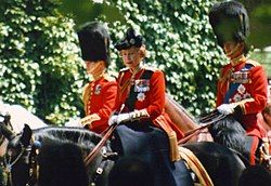 Elizabeth in red uniform on a black horse