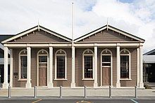 A photo of a brown one-storey public library building