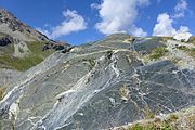 Glacial striations on an eroded rock alongside the Moiry Glacier, Switzerland, visible in the lower right quarter of the image.