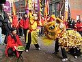 Lion danceer at Chinese New Year festival in Boston's Chinatown about to kick lettuce