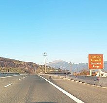 Road sign with the inscription "Foinikas River" (On the Olympia Odos highway bridge over the river)