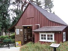 A red barn with white trim and a shingle roof