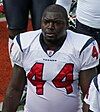 A football player standing without a helmet