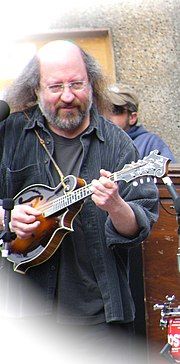 Sandy Rothman on stage, playing a mandolin