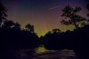 Shooting star seen through an aurora, taken over the Kewaunee River.