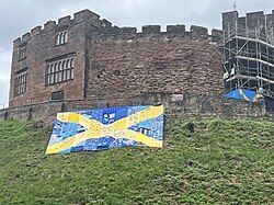 Mercia flag created by community groups hung over the motte of Tamworth castle to celebrate Athelstan 1100