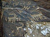 A rock with a goat and a totem depicted on it in Gamigaya area