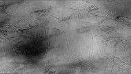 Weinbaum crater region showing dust devil tracks, as seen by CTX camera (on Mars Reconnaissance Orbiter). Field of picture is just outside rim of crater and is an enlargement of the previous image of Weinbaum crater.