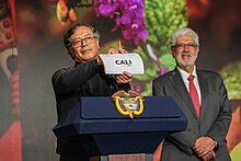 President of Colombia, Gustavo Petro, announces the city of Cali as the host for the United Nations Biodiversity COP16, by showing a small paper with the city's name printed on it in capital letters.