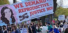 NMRJ protesters at a march in Seattle on 5/14/2022. Many people are holding signs about abortion, but the largest is a banner referring to Rosie Jiménez.