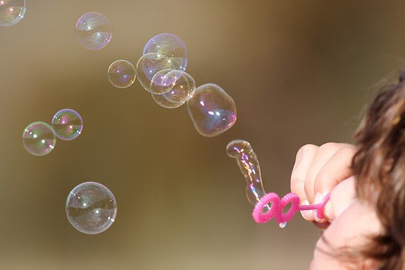 File:Girl blowing bubbles.jpg