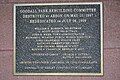 A plaque, located within the grandstand, that commemorates the park's rebuilding after it was destroyed by an arsonist.