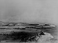 Lithograph giving an overview of a river valley and Fort Pierre Chouteau, surrounded by tipis.