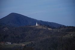 St. Lawrence's Church in Okroglice. Big Kozje Hill in the background.