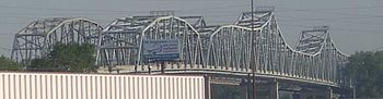 A pair of bridges, with of lot of steel trusses.