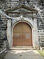 Side portal decorated with a triangular pediment