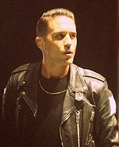 Shot of G-Eazy wearing a black jacket and shirt.