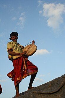 Smiling, costumed man with a drum