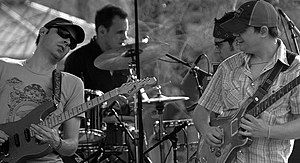 From left to right: Jake Cinninger, Kris Myers, Ryan Stasik and Brendan Bayliss performing at a Steak 'N Shake parking lot in April 2007.