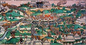 A fortified town on a river surrounded by soldiers