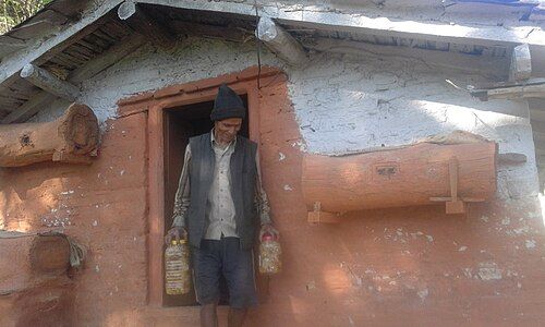 Wooden hives and farmer with packed honey.