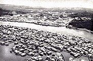 Aerial view of Pusat Bandar (center) and Kampong Ayer (foreground), with the view of Kianggeh River (right) in the 1960s