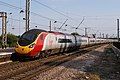 In standard livery, 11 car, shows a whole unit, but part of the unit is obscured by fencing/OHLE and the light is a little uneven.