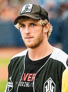 Headshot of Logan Paul, a young, white, blond man with a beard, wearing a boxing shirt and .