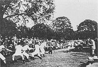 A game of tug of war in the centre with a large crown on the left.