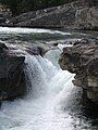 Elbow Falls flows over a Cadomin Formation outcrop.