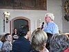 Michael Herrmann announcing a concert of Andreas Scholl and members of the Baroque orchestra Accademia Bizantina at the church of Hallgarten, 16 July 2011