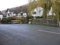 Ludlow Road where it crosses the small brook Ashes Hollow - the beige milestone, facing the other way, can be seen