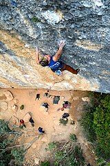 Belgian climber Muriel Sarkany on an overhanging limestone climb in Spain