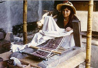 Preparing to weave geringsing on a back-strap loom. Geringseng is a culturally-significant double ikat fabric of Bali.[17][18]