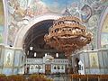 Interior view of the church. Beneath the dome hangs the central circular chandelier with depictions of the saints and apostles which in traditional Greek orthodox churches is called the horos.