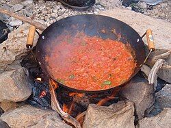 Qalayet Bandora cooked over a campfire in Wadi Mukheiris, near the Jordanian coast of the Dead Sea.