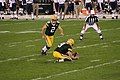 Mason Crosby kicks a field goal, held by Jon Ryan