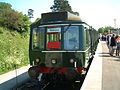 The first passenger train to cross Bridge 13, with headboard from 1981 (Class 117 51402 has since moved to the Strathspey Railway)