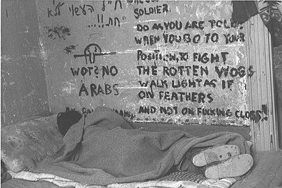 Israeli soldier sleeping during the 1948 Arab–Israeli War, Chad is seen on the wall together with inscription "Wot? No Arabs", November 1948.