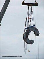 One of four main cable compactors is lifted into place.