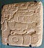 A Classic Period glyph with a representation of Itzamna with the body of a bird, found in the Plaza of the Dead Sun in Toniná and now in the site museum.