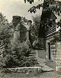 c.1936 view of site; log building on the right is a remnant of the 1780s fort.[1]