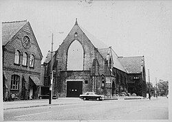 Black and white photo of a church on a street